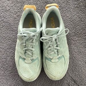 - Hoka One One Clifton L, Size 12 Women’s, Size 11 Men, Light Blue Suede